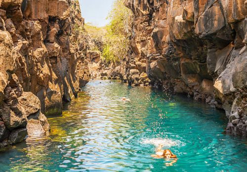 Puerto Ayora, Galapagos, Ecuador - April 2, 2016: People are swimming in  Las Grietas on Santa Cruz Island in Galapagos. It is popular tourist destination on Santa Cruz Island.